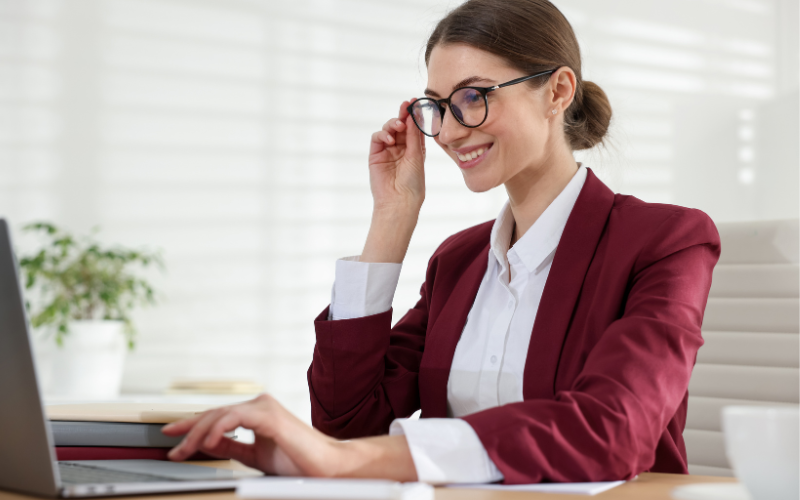 A professional advisor meeting with a client to discuss retirement income in a San Diego office.