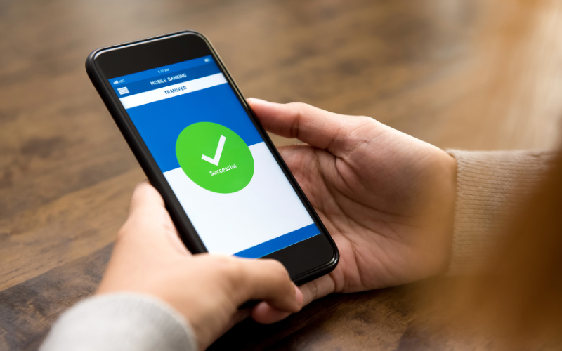 man using his phone wondering what the best order for for Withdrawing his Retirement Accounts