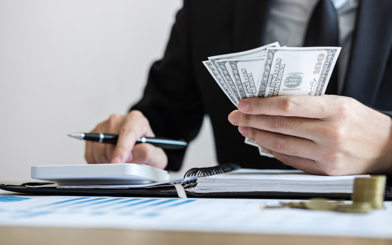 man using a calculator to solve how much his retirement income will be affected by taxes