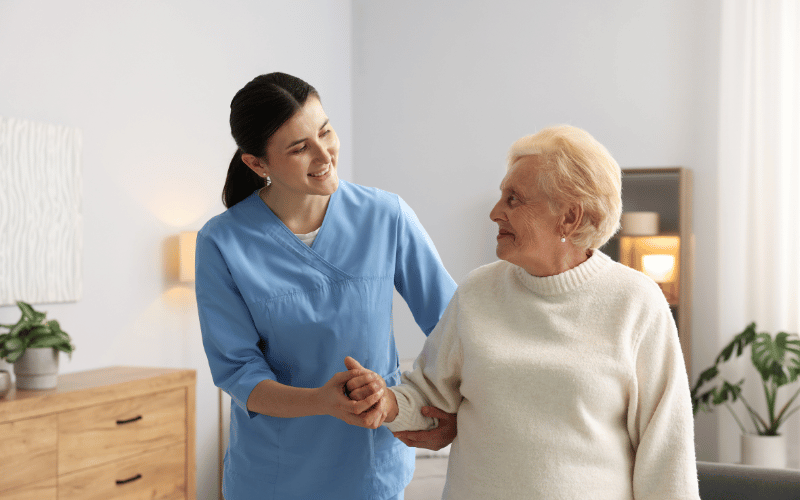 elderly woman receiving care from a nurse in her home. This is know as long-term care